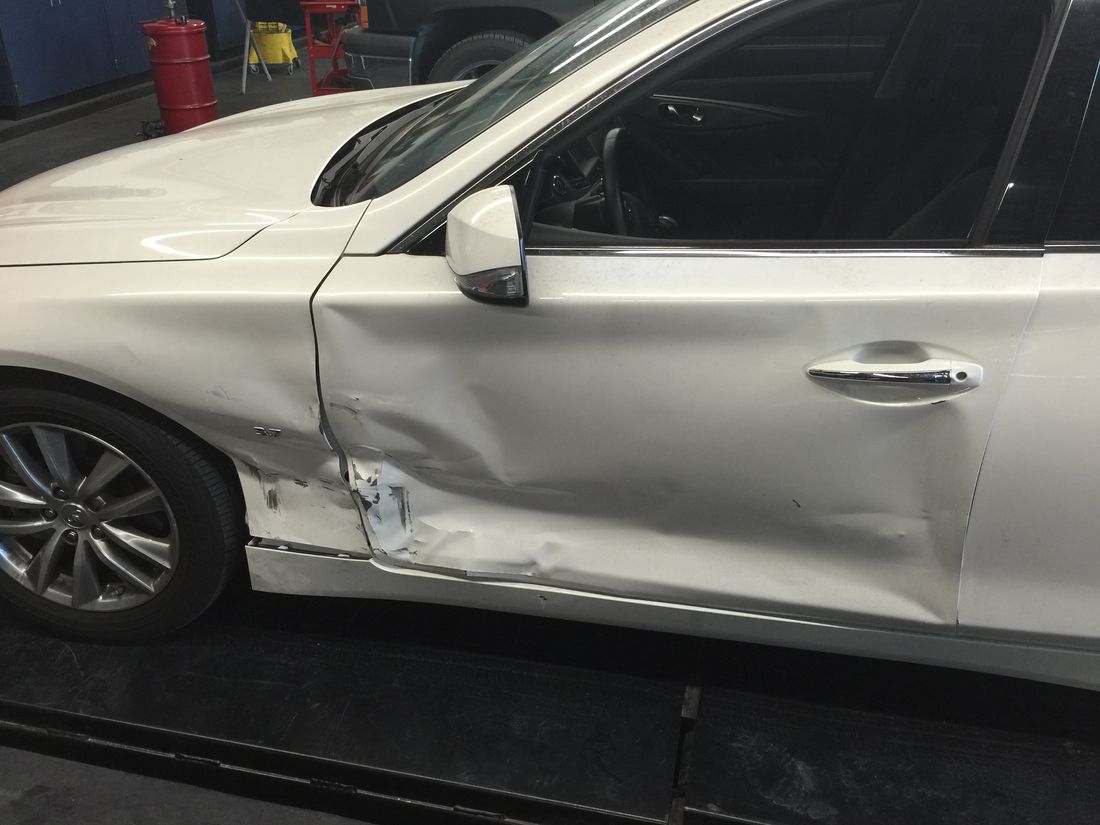 Infiniti Q50 with crumpled front door before collision repair