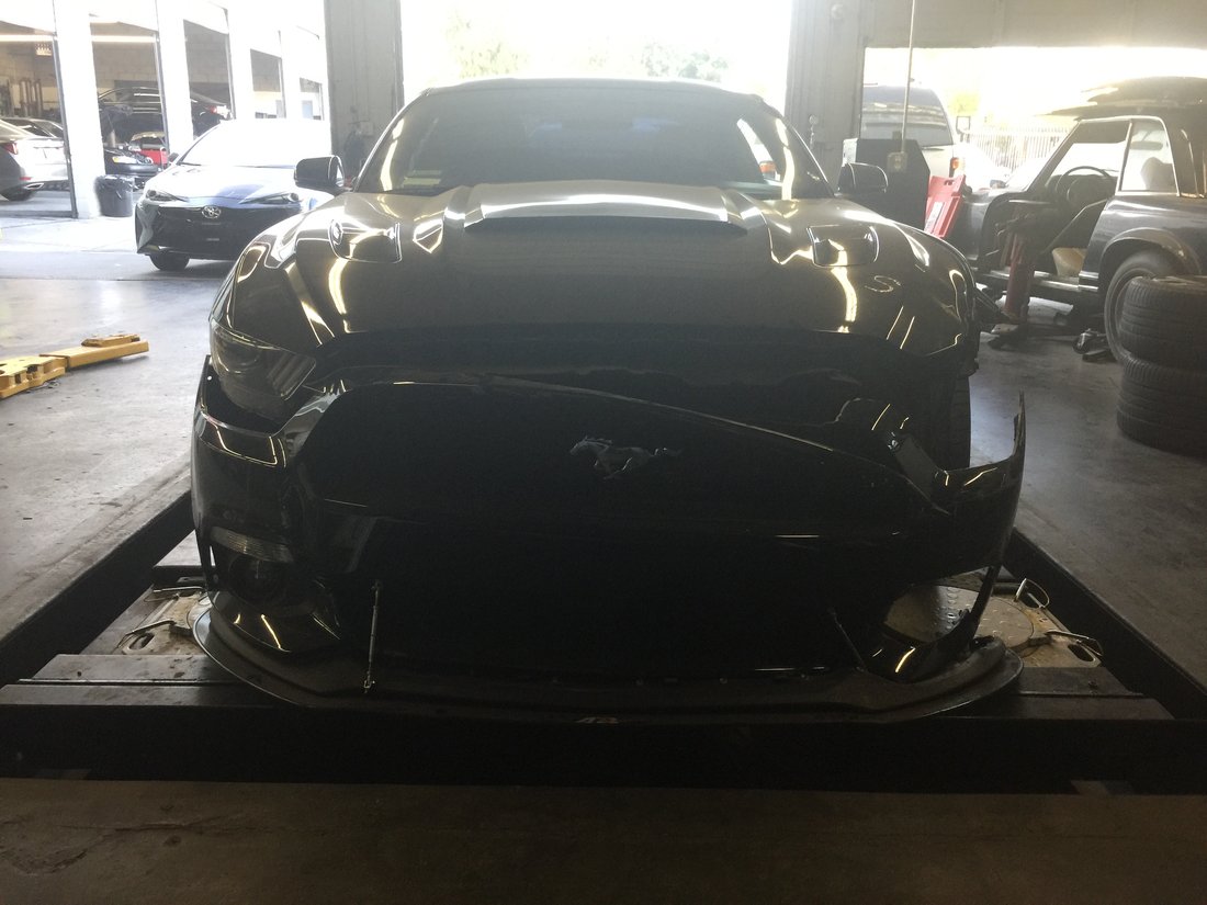 Ford Mustang with front bumper and grille damaged before collision repair