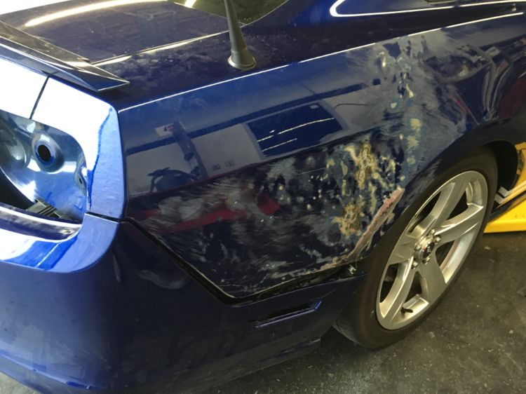Ford Mustang GT with paint damage before refinishing